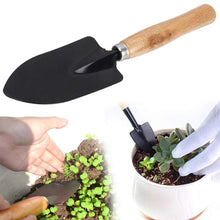 Detailed view of gardening tools set including rake and trowel.